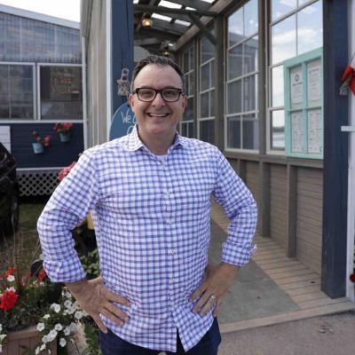 John Catucci posing for a photoshoot for his Instagram feed.